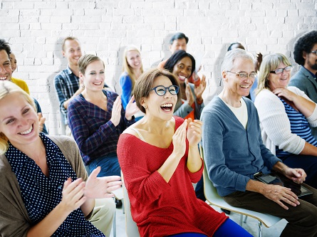 Community sitting and clapping