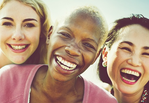 Three people smiling and facing the camera
